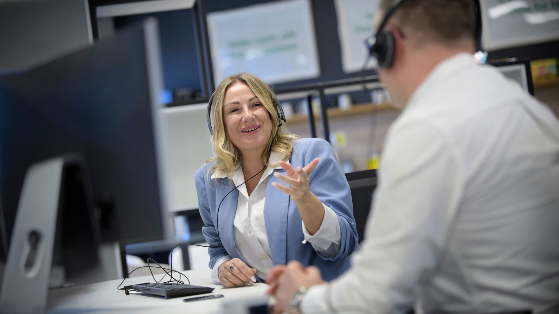 A woman and a man in a call center talking.